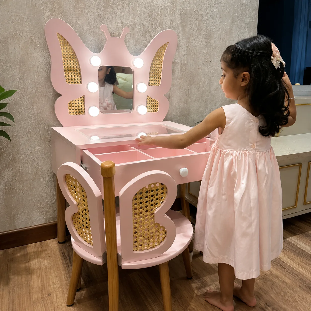 Child at butterfly vanity table